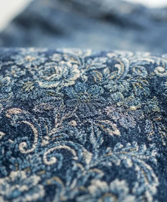 A detailed close-up of the blue floral jacquard fabric on the Mode Of One Meadow straight-fit jeans, showing the intricate pattern.