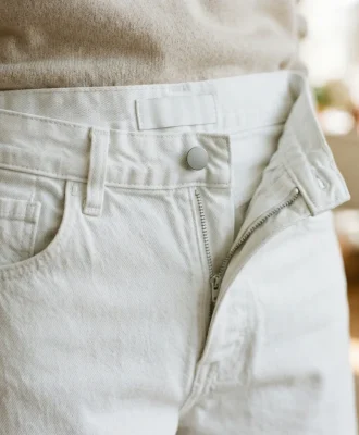 A close-up of the waistband and wash detail on the Mode Of One white washed baggy jeans, showing the soft, faded fabric.
